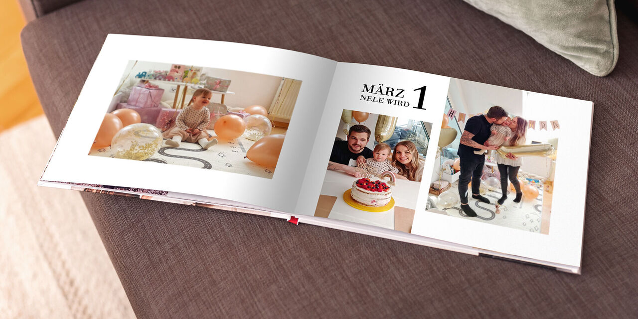 Blick ins selbst gestaltete CEWE FOTOBUCH: Auf einer Doppelseite sind drei Fotos von Tochter Neles erstem Geburtstag zu sehen.